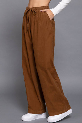 Brown wide-leg corduroy pants with elastic drawstring waist and side pockets