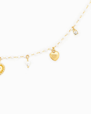 Gold-tone pearl chain necklace with heart charms and crystal drop pendant