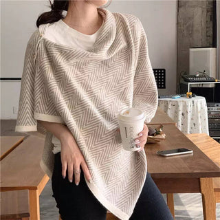 Beige chevron knit poncho wrap with button detail, worn over white tee