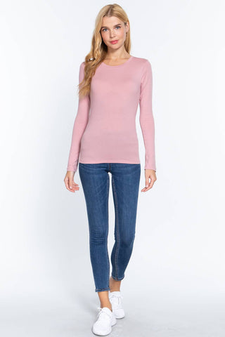 Pink long sleeve crew neck fitted cotton jersey top worn with blue skinny jeans