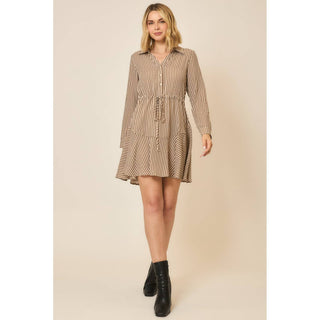 Model wearing a long-sleeve vertical stripe button-front shirt dress with tiered ruffle hem and ankle boots