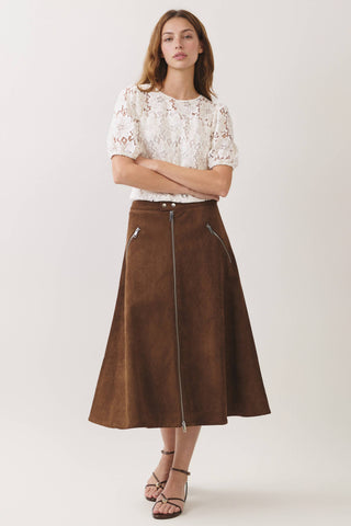 Model wearing a brown suede midi skirt with full front zipper and zip pocket details