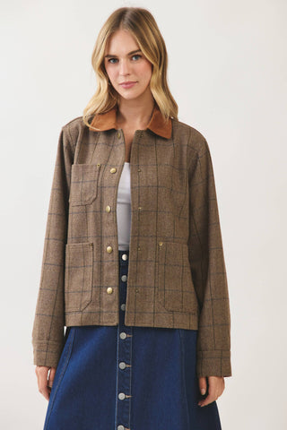 Model wearing a brown plaid chore jacket with gold snap buttons and contrast collar