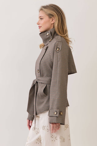 Side view of cropped plaid trench coat with high collar, gold buttons, and waist tie
