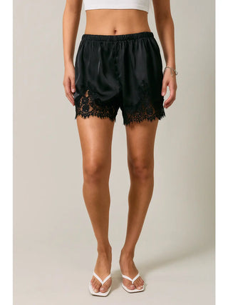 Black satin lounge shorts with floral lace trim hem and elastic waistband