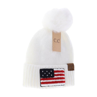 White knit C.C beanie with pom-pom and American flag chenille patch