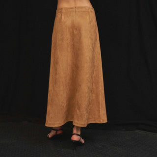 Tan faux suede maxi skirt back view, A-line silhouette, black strappy heels