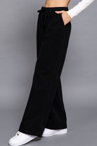 Black wide-leg corduroy pants with elastic drawstring waist and side pockets