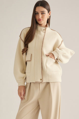 Cream boucle bomber jacket with brown whipstitch trim and front patch pockets