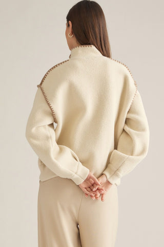 Cream oversized wool jacket with tan whipstitch trim detail, back view