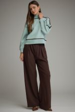 Entro light blue cropped sweater with black trim detail, paired with brown wide-leg trousers