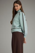 Entro light blue turtleneck sweater with dark trim, paired with brown wide-leg pants