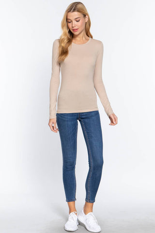 Women's beige long sleeve crew neck fitted cotton jersey top with blue skinny jeans