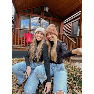 Two women wearing mixed tone boucle cuff C.C beanies in beige and mauve