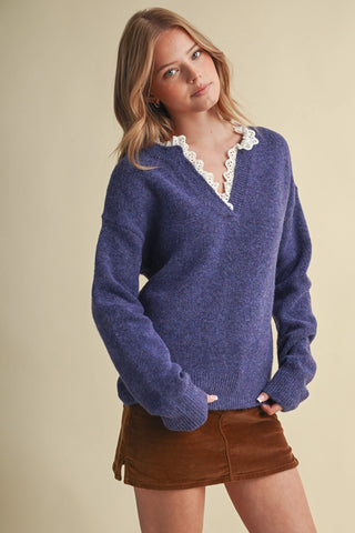 Blue V-neck knit sweater with white eyelet lace ruffle collar trim