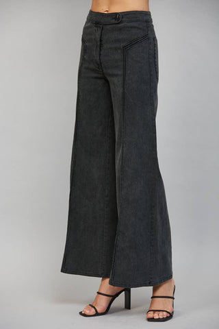 High waisted wide leg flare pants with front button closure and seam detailing, styled with heels