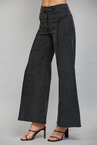 High waisted wide leg flare pants with front button closure and seam detailing on model