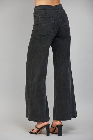 Back view of high waisted wide leg flare pants with rear pocket and block heel sandals