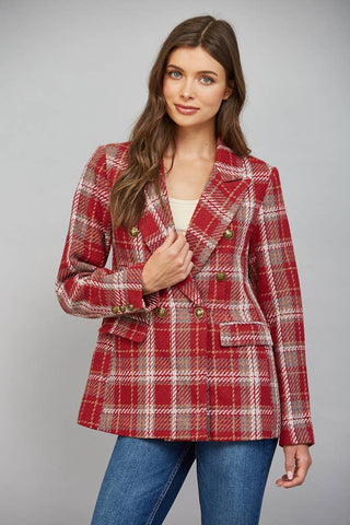 Model wearing a double-breasted plaid blazer with gold buttons over blue jeans