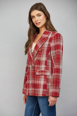 Model wearing a red plaid double-breasted blazer with gold buttons and notched lapels