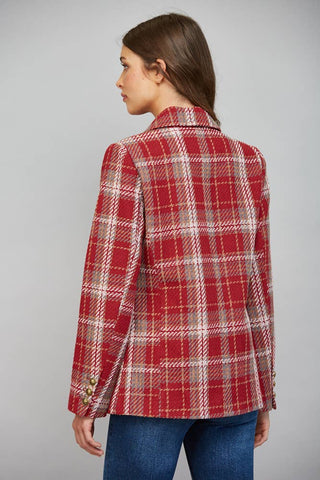 Back view of a woman wearing a red plaid double breasted blazer with gold buttons