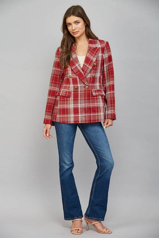 Model wearing a double-breasted plaid blazer with gold buttons paired with flare jeans