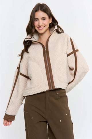Cream sherpa zip-up jacket with brown suede trim detailing and high collar
