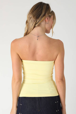 NIKIBIKI pale yellow strapless two-layer tube top, back view, paired with dark denim