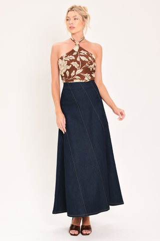 Model wearing a dark indigo denim maxi skirt with diagonal seams and A-line silhouette