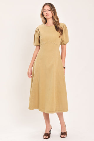 Model wearing a midi-length woven dress with puff sleeves, round neckline, and A-line skirt