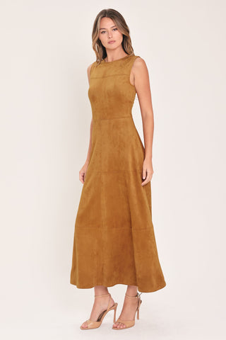 Model wearing a sleeveless faux suede midi dress with round neckline and flared circle skirt