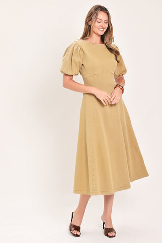 Model wearing a midi dress with puff sleeves, round neckline, and full circle skirt