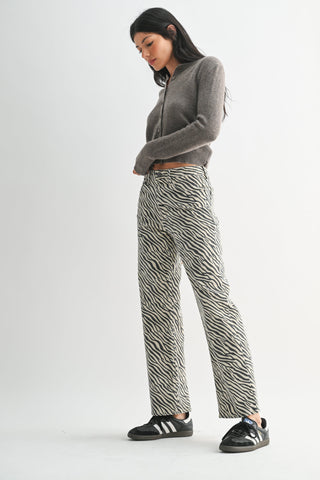 Model wearing high-rise straight-leg pants with zebra print pattern and gray cropped cardigan