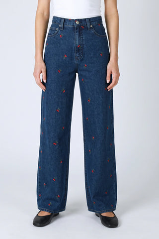 High-rise wide-leg dark denim jeans with scattered red cherry embroidery pattern throughout