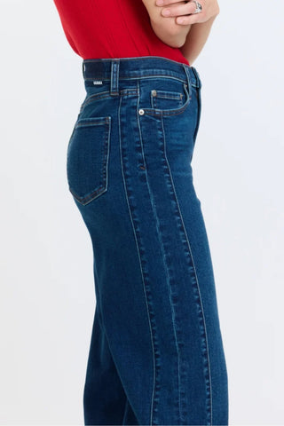 Side view close-up of high rise wide ankle jeans with front seam detail on model