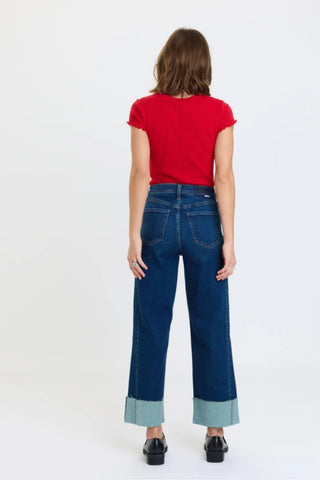 Back view of wide-leg high-rise ankle jeans with contrast cuffed hem on female model