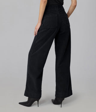 Back view of high rise wide leg corduroy pants with patch pocket, styled with black heels