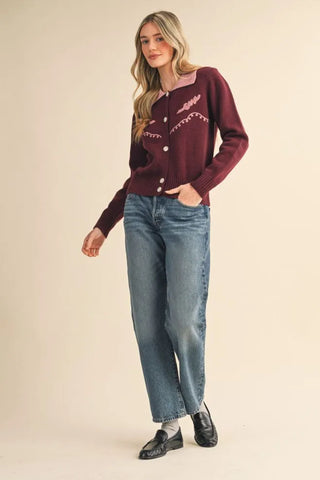 Burgundy western knit cardigan with pink embroidery and pearl buttons