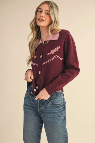 Burgundy western cardigan with pink embroidery, pearl buttons, and pink contrast collar