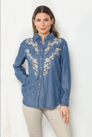 Woman wearing the Prescott Embroidered Denim Shirt, a medium-wash denim shirt with ivory floral embroidery across the chest and yoke