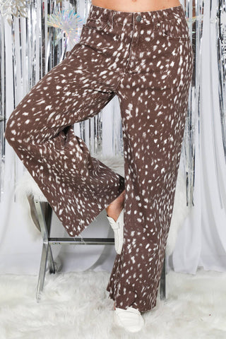 Wide-leg brown pants with white speckled deer print, paired with white sneakers